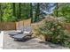 Comfortable poolside loungers with decorative pillows, surrounded by a wooden fence and lush greenery at 226 Smith Dr, Durham, NC 27712