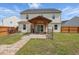 Large backyard with a wooden pergola and brick patio, ideal for outdoor entertaining and relaxation at 227 Sumter Ct, Burlington, NC 27217