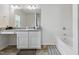 Bathroom featuring a granite-look vanity with ample counter space and a separate tub at 227 Sumter Ct, Burlington, NC 27217
