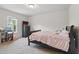 Cozy bedroom with a dark wood bed frame, soft carpet, and natural light from a window at 227 Sumter Ct, Burlington, NC 27217
