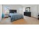 Bright bedroom with two large windows, a king bed, and a dresser at 227 Sumter Ct, Burlington, NC 27217