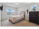 Bright bedroom with a bed, dark wood dresser, and a view of the neighborhood outside the window at 227 Sumter Ct, Burlington, NC 27217