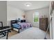 Spacious bedroom featuring carpet, ample light, and space for both rest and hobbies at 227 Sumter Ct, Burlington, NC 27217