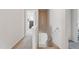 Well-lit hallway featuring plush carpeting, modern railings, and access to other rooms at 227 Sumter Ct, Burlington, NC 27217
