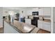 Open concept kitchen featuring stone countertops and appliances with an adjacent dining area at 227 Sumter Ct, Burlington, NC 27217