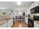 Modern kitchen featuring countertops and stainless steel appliances with an adjacent dining area at 227 Sumter Ct, Burlington, NC 27217