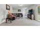 Cozy living room with carpet, comfortable seating, and a mounted television at 227 Sumter Ct, Burlington, NC 27217