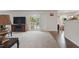 Open living room with wood flooring, neutral carpet, and sliding glass doors to the home's backyard at 227 Sumter Ct, Burlington, NC 27217