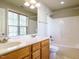 Bright bathroom featuring a double sink vanity with modern fixtures and a shower-tub combination at 23 Great View Ct, Clayton, NC 27527