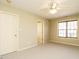 Bedroom featuring neutral carpet, ceiling fan, and two closets at 23 Great View Ct, Clayton, NC 27527