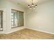 Bright dining room featuring hardwood floors, large window, and stylish chandelier at 23 Great View Ct, Clayton, NC 27527
