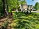 Grassy front yard with manicured lawn and multiple chairs, perfect for entertaining guests at 23 Great View Ct, Clayton, NC 27527
