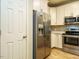 Kitchen with stainless steel appliances, white cabinets, and granite countertops at 23 Great View Ct, Clayton, NC 27527
