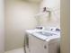 Convenient laundry room featuring a modern washer and dryer with wire shelving at 23 Great View Ct, Clayton, NC 27527