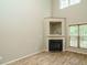 Spacious living room featuring a cozy fireplace, built-in shelving, and beautiful hardwood floors at 23 Great View Ct, Clayton, NC 27527