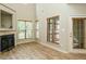 Inviting living area boasting large windows, a cozy fireplace, hardwood floors, and access to the outdoors at 23 Great View Ct, Clayton, NC 27527