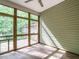Relaxing sunroom with screened windows and a concrete floor at 23 Great View Ct, Clayton, NC 27527