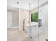 The stylish bathroom features a soaking tub, glass shower, tile floors, and a bright window with forest views at 2312 Laurelford Ln, Wake Forest, NC 27587