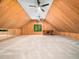 Lofted bonus room with wood paneled walls, recessed lighting, ceiling fans, and two windows at 2312 Laurelford Ln, Wake Forest, NC 27587