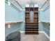 The walk-in closet is designed with custom shelving, hanging rods, and an ottoman for convenience at 2312 Laurelford Ln, Wake Forest, NC 27587