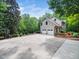 Spacious home with a large driveway and two-car garage, surrounded by trees and manicured landscaping at 2312 Laurelford Ln, Wake Forest, NC 27587