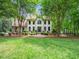 Charming two-story white brick home with a landscaped yard and mature trees enhancing its curb appeal at 2312 Laurelford Ln, Wake Forest, NC 27587