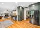 Spacious kitchen with sage cabinets and stainless steel appliances, seamlessly connects to a comfortable living area at 2312 Laurelford Ln, Wake Forest, NC 27587