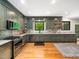 This kitchen features sage cabinets, stainless steel appliances, and hardwood floors, combining style and functionality at 2312 Laurelford Ln, Wake Forest, NC 27587