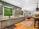 Open-concept kitchen featuring sage cabinets, hardwood floors, stainless appliances, and a seamless transition to living space at 2312 Laurelford Ln, Wake Forest, NC 27587