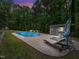 Backyard pool with patio, shed, and lounge furniture amid lush greenery for relaxation and recreation at 2312 Laurelford Ln, Wake Forest, NC 27587