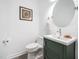 This powder room features modern fixtures, a sink with cabinet, a stylish mirror, and natural light at 2312 Laurelford Ln, Wake Forest, NC 27587