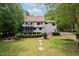 Expansive rear exterior of home with screened in porch, back yard, and landscaped areas at 2312 Laurelford Ln, Wake Forest, NC 27587