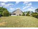 Large, well-maintained backyard featuring lush green grass and a charming screened-in porch at 2437 Everstone Rd, Wake Forest, NC 27587