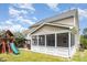 View of the backyard featuring a screened-in porch and play set at 2437 Everstone Rd, Wake Forest, NC 27587
