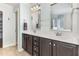 Bathroom with a dual sink vanity, dark cabinets, and large mirrors for a functional design at 2437 Everstone Rd, Wake Forest, NC 27587