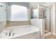 Luxurious bathroom featuring a soaking tub and separate glass-enclosed shower at 2437 Everstone Rd, Wake Forest, NC 27587