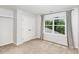 A bedroom with closet and carpet, plus a large window overlooking trees at 2437 Everstone Rd, Wake Forest, NC 27587