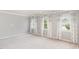 A bedroom with large windows and light-colored carpet at 2437 Everstone Rd, Wake Forest, NC 27587