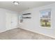 A bedroom with carpet, two windows with shelves, and a closet at 2437 Everstone Rd, Wake Forest, NC 27587