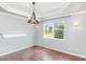 Airy dining room has natural light, tray ceiling, and decorative light fixture, and a built-in shelf at 2437 Everstone Rd, Wake Forest, NC 27587