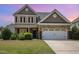 Charming two-story home with a well-manicured lawn and a two-car garage at 2437 Everstone Rd, Wake Forest, NC 27587