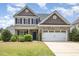 Charming two-story home with a brick facade, manicured lawn, and attached two car garage at 2437 Everstone Rd, Wake Forest, NC 27587