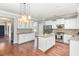 Well-appointed kitchen with white cabinetry, stainless appliances, granite counters and island seating at 2437 Everstone Rd, Wake Forest, NC 27587