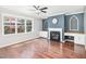 A cozy living room is filled with natural light, featuring a fireplace and hardwood floors at 2437 Everstone Rd, Wake Forest, NC 27587