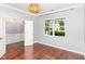 A modern home office features hardwood flooring and ample natural light from the window at 2437 Everstone Rd, Wake Forest, NC 27587
