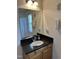 Bathroom featuring dark countertops, a framed mirror, and coordinated towel racks at 2528 Beech Gap Ct, Raleigh, NC 27603
