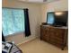 Bedroom featuring a dresser and a window with blinds, complete with a television at 2528 Beech Gap Ct, Raleigh, NC 27603