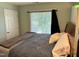Cozy bedroom featuring neutral walls, large window with blinds, and comfortable bed at 2528 Beech Gap Ct, Raleigh, NC 27603