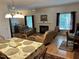 Comfortable living room with fireplace, piano, and large windows filling the space with light at 2528 Beech Gap Ct, Raleigh, NC 27603