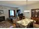 Cozy living room with a fireplace, hardwood floors, dining room, and comfortable seating at 2528 Beech Gap Ct, Raleigh, NC 27603